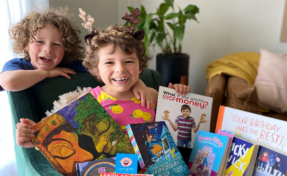Kids smiling with books