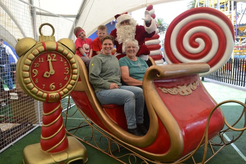 Family Christmas Party, family sat in Santa's sleigh