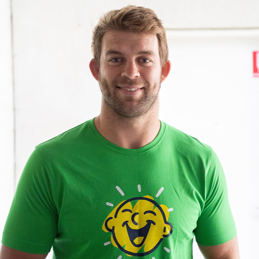 Christian Welch smiling in Camp Quality shirt