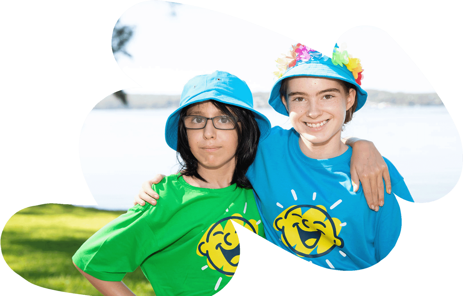 Two children at a Camp Quality camp stand with their arms around each other's shoulders