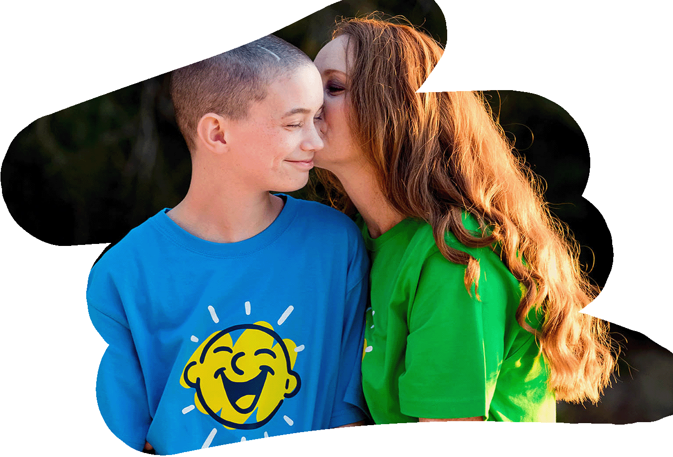 A mum kisses her son on the cheek at a Camp Quality retreat