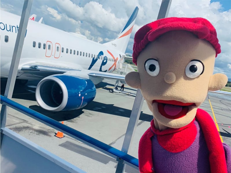 Puppet next to plane