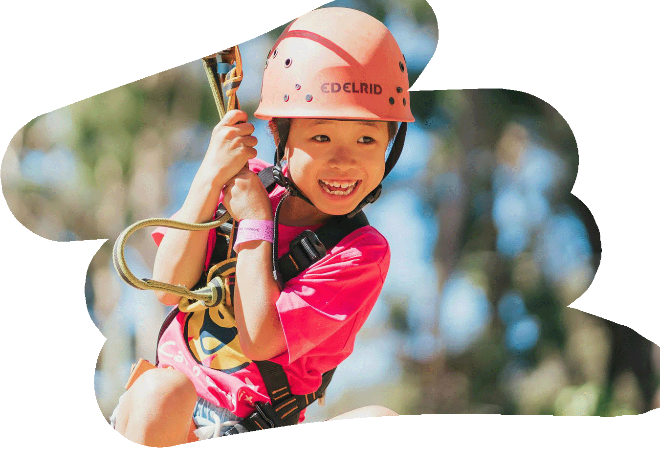A girl rides on the flying fox at a Camp Quality Kids' Camp