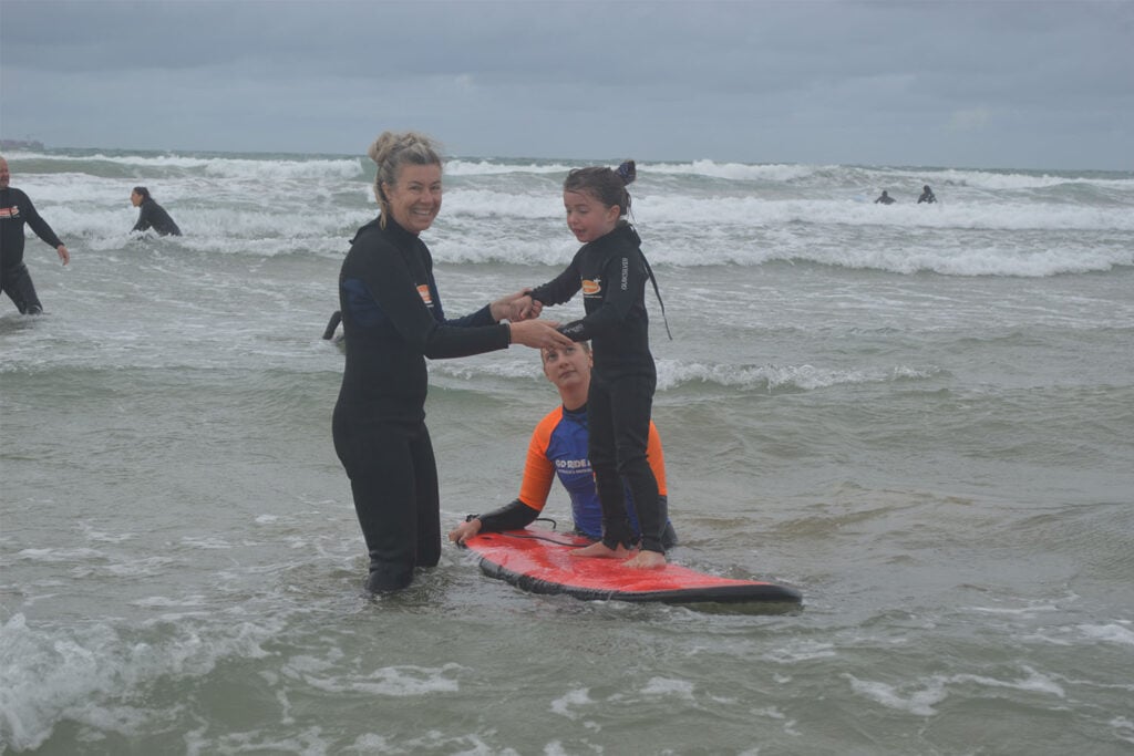 Child learning how to surf