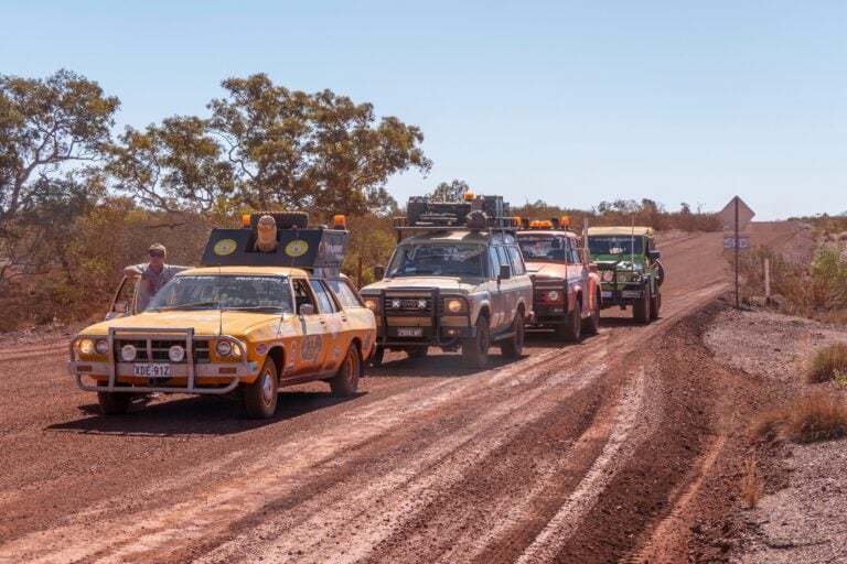Cars travel along the dusty roads of the West Australian outback for Camp Quality's WesCarpade event