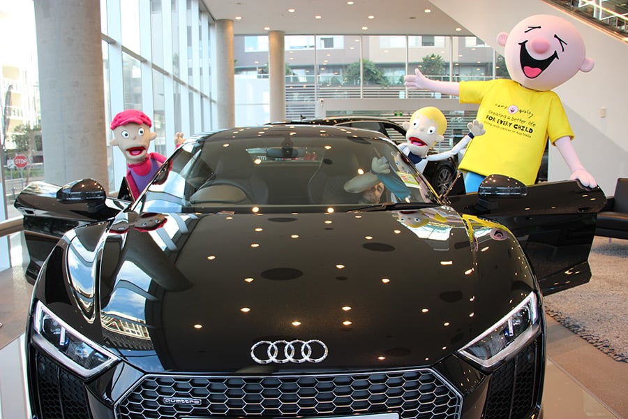 Giggle and Camp Quality puppets in an Audi car