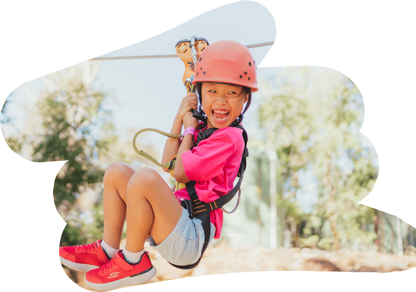 A girl on a flying fox at a Camp Quality camp