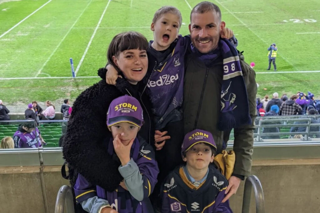 Family in Storm merch in front of field