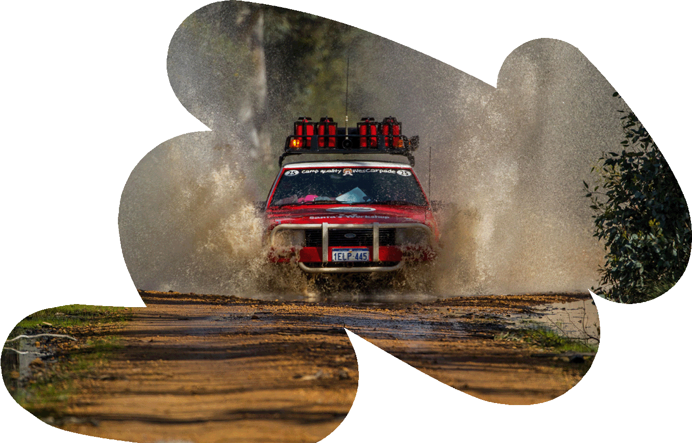 A Red Car drives through water on wesCarpade