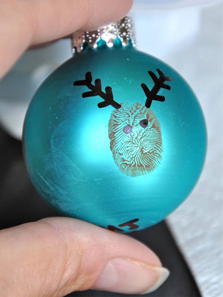 Blue ornament with a fingerprint mark and antlers