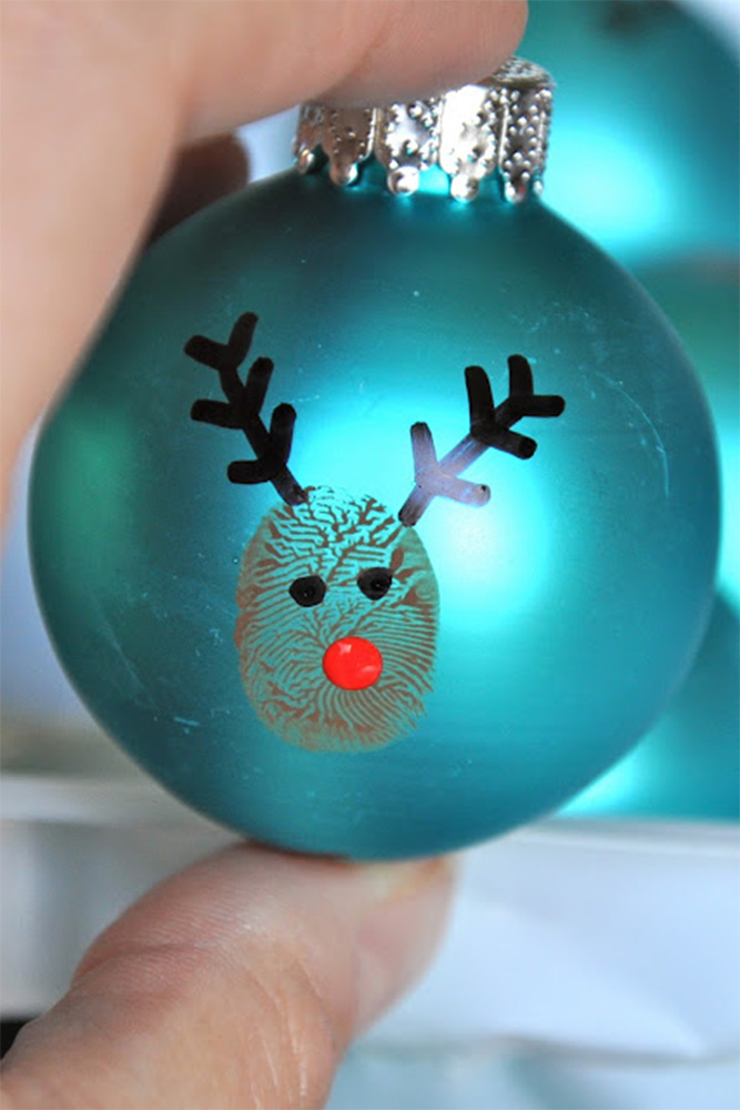Blue ornament with a fingerprint with a reindeer drawn on