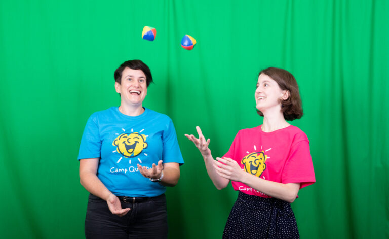 Two staff members juggling