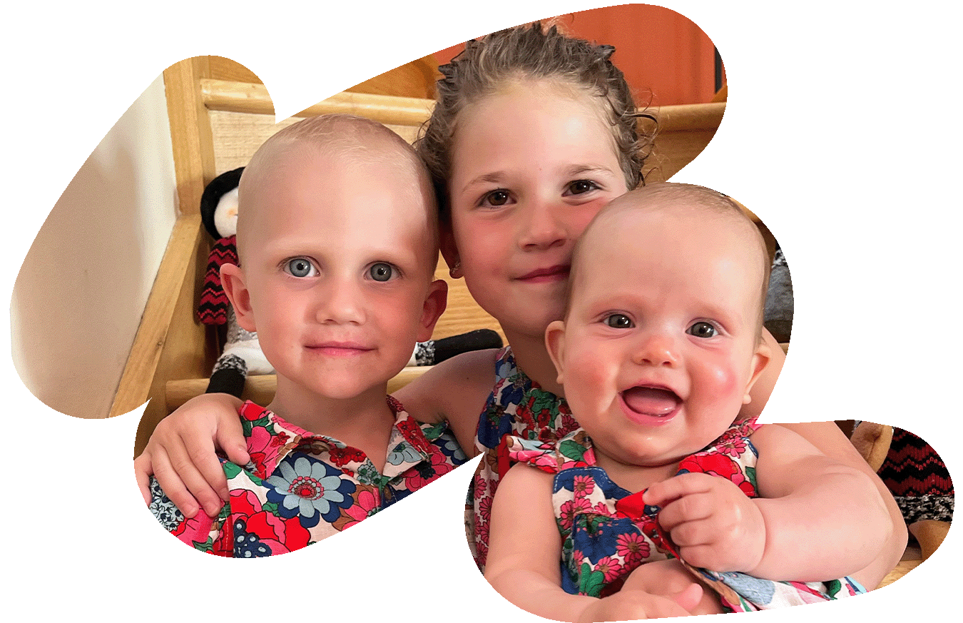 Theo and sisters smiling together at Christmas