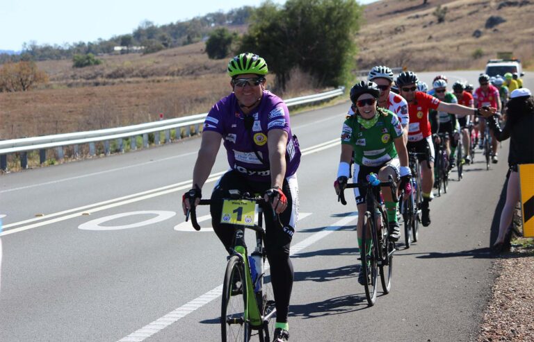 400kms participants riding bikes down a road