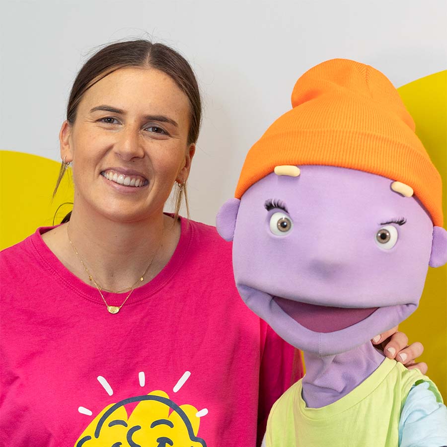 Maddy Proud standing next to Camp Quality Puppet